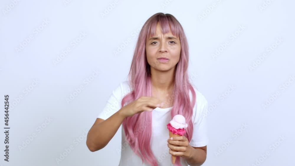 holding a cornet ice cream looking far away with hand to look something over isolated background holding a cornet ice cream looking far away with hand to look something over isolated background