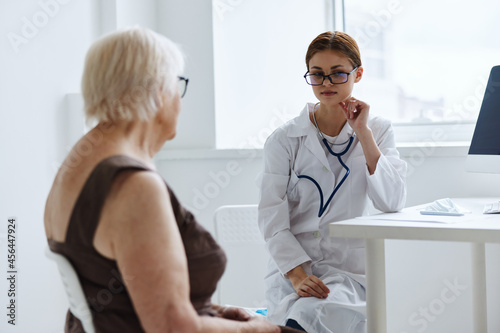 elderly woman examination by a doctor medical office