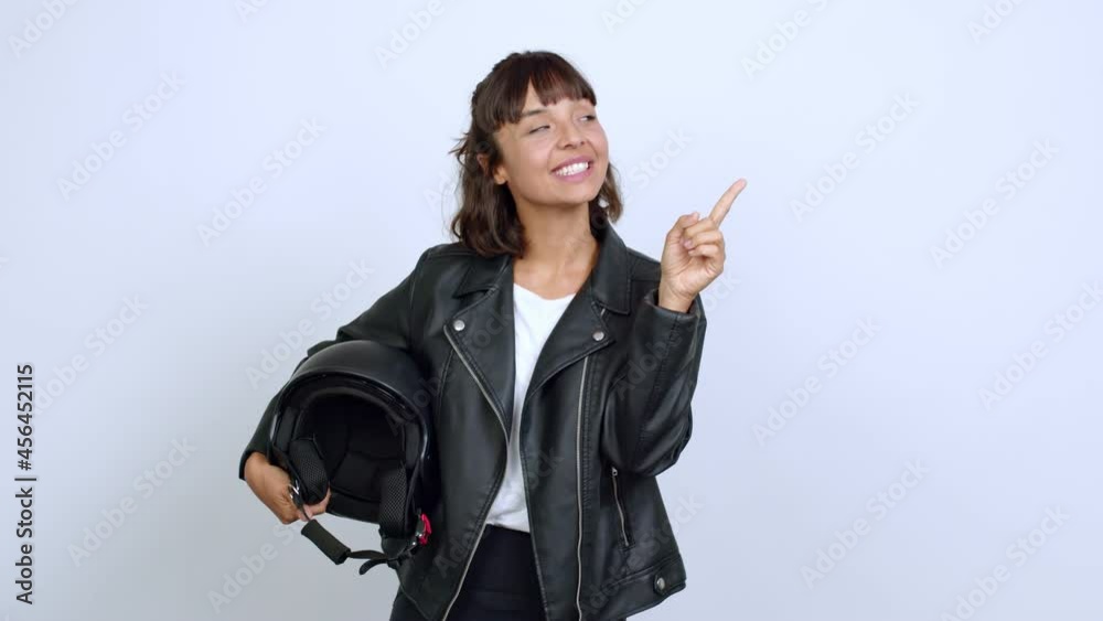 holding a motorcycle helmet pointing a great idea and looking up over isolated background holding a motorcycle helmet pointing a great idea and looking up over isolated background