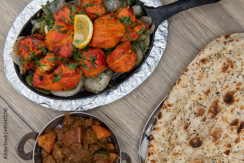 Skillet cooked chicken seasoned and sauteed and served with naan bread and curry bowl for a perfect meal