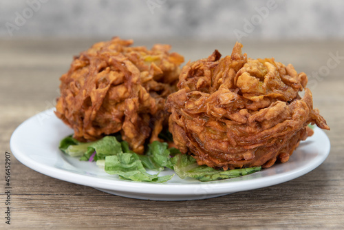 Deep fried bhaje onion blossoms is perfect appetizer from Indian restaurant cooked and seasoned perfectly photo