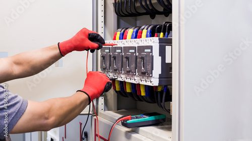 Electrical engineers check electrical control equipment.