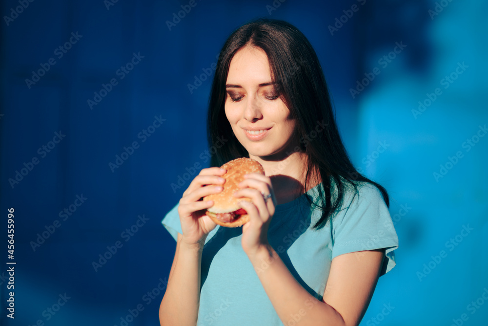 Beautiful Young Woman Holding a Delicious Burger Beautiful Young Woman Holding a Delicious Burger