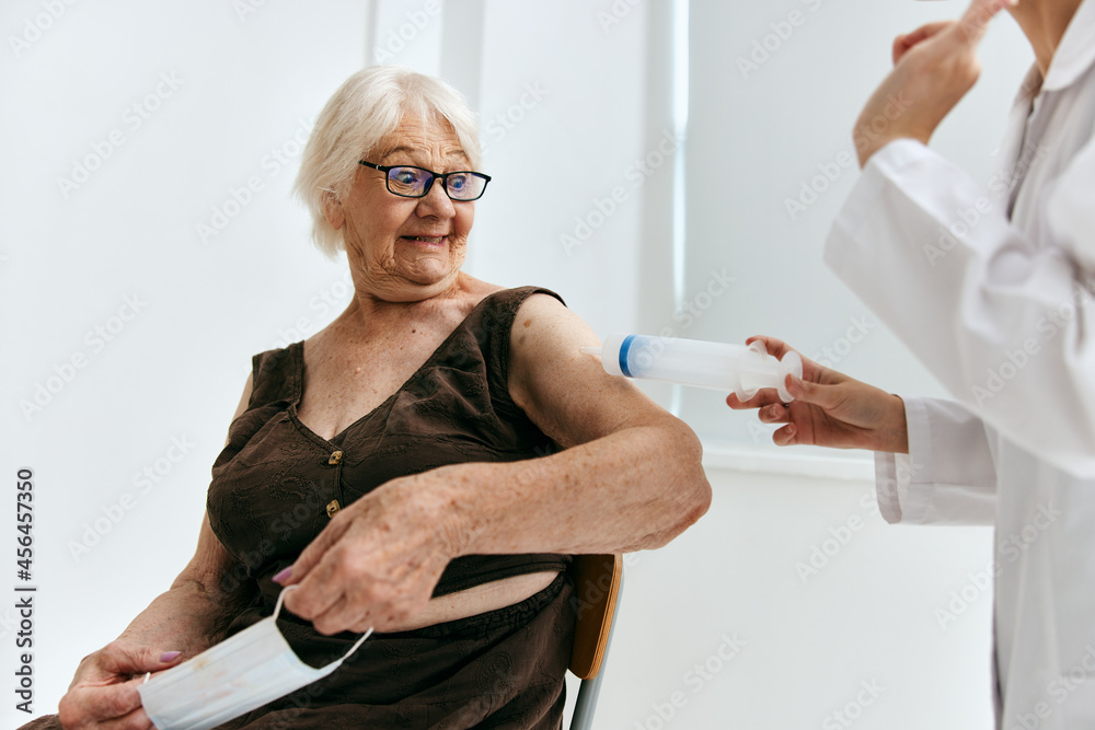 Fototapeta premium emotional nurse and patient syringe injection vaccine passport