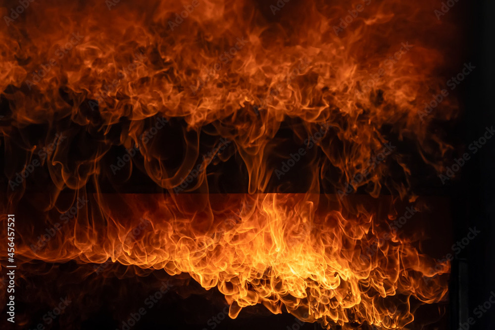 Fototapeta premium Burning red hot sparks rise from large fire,Close Up Fire flames from gas explosion on black background.