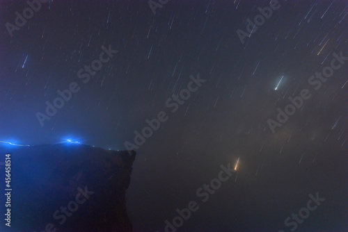 Beautiful night landscape The colorful star trails on the sky. Night time lapse photography.