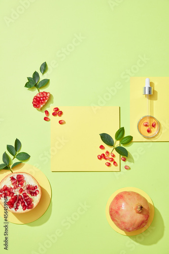 Fototapeta Naklejka Na Ścianę i Meble -  Empty podium for cosmetics with pomegranate extract top view. .Glass petri dish with cosmetic products. Red pomegranate extract in Laboratory. Flatlay
