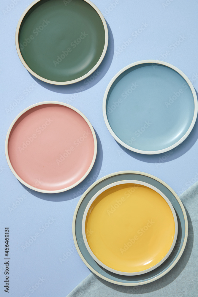 Still life of pastel colored ceramic dishes with linens napkins. Topview. Still life of pastel colored ceramic dishes with linens napkins. Topview.