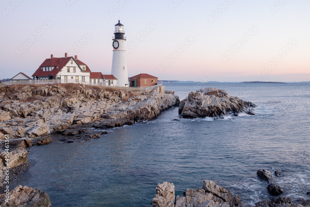 The Portland Head Lighthouse on Cape Elizabeth moments before Sunrise lights up the rocks and the lighthouse