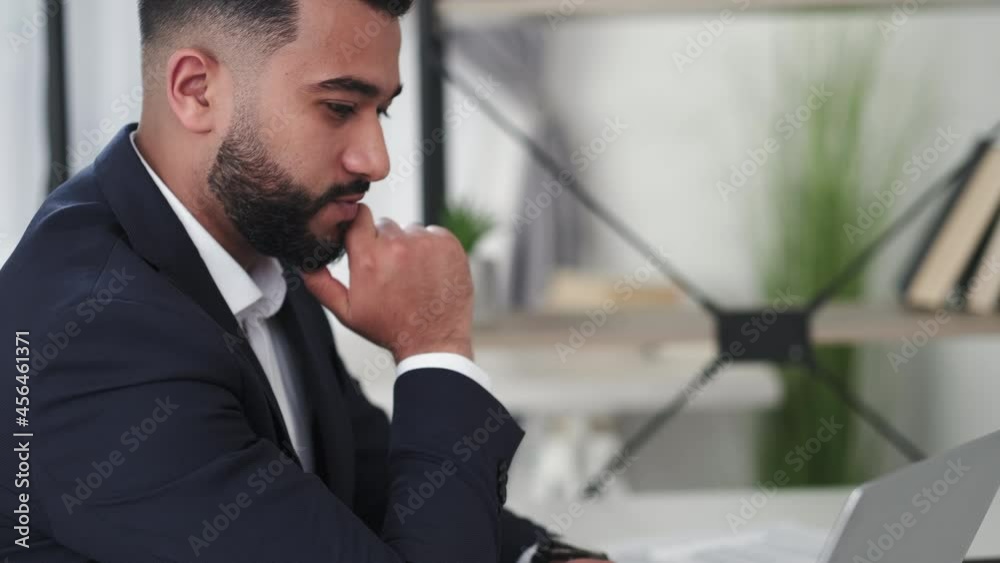 Business communication. Worried man. Work inspiration. Handsome involved guy in elegant suit concentrating on laptop online chat sitting light office room interior. Business communication. Worried man. Work inspiration. Handsome involved guy in elegant suit concentrating on laptop online chat sitting light office room interior.