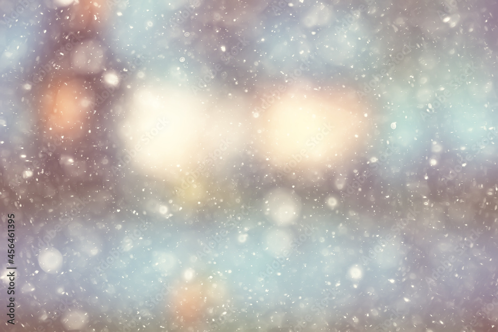 Fototapeta premium colorful background snow snowfall evening christmas lights, soft light blurry