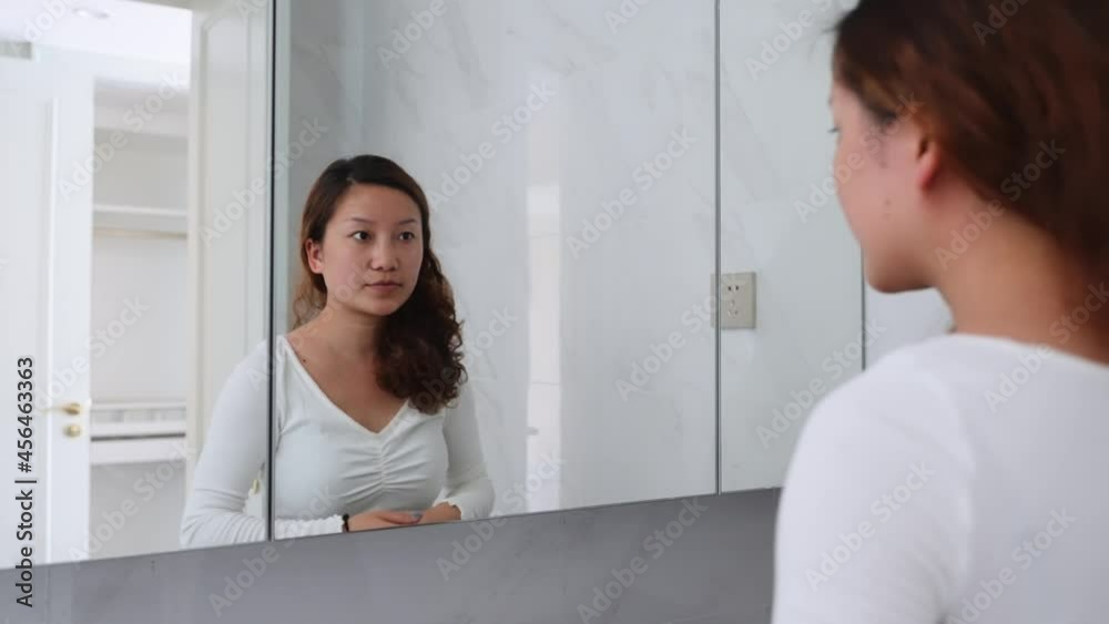 young woman make up in front of mirror