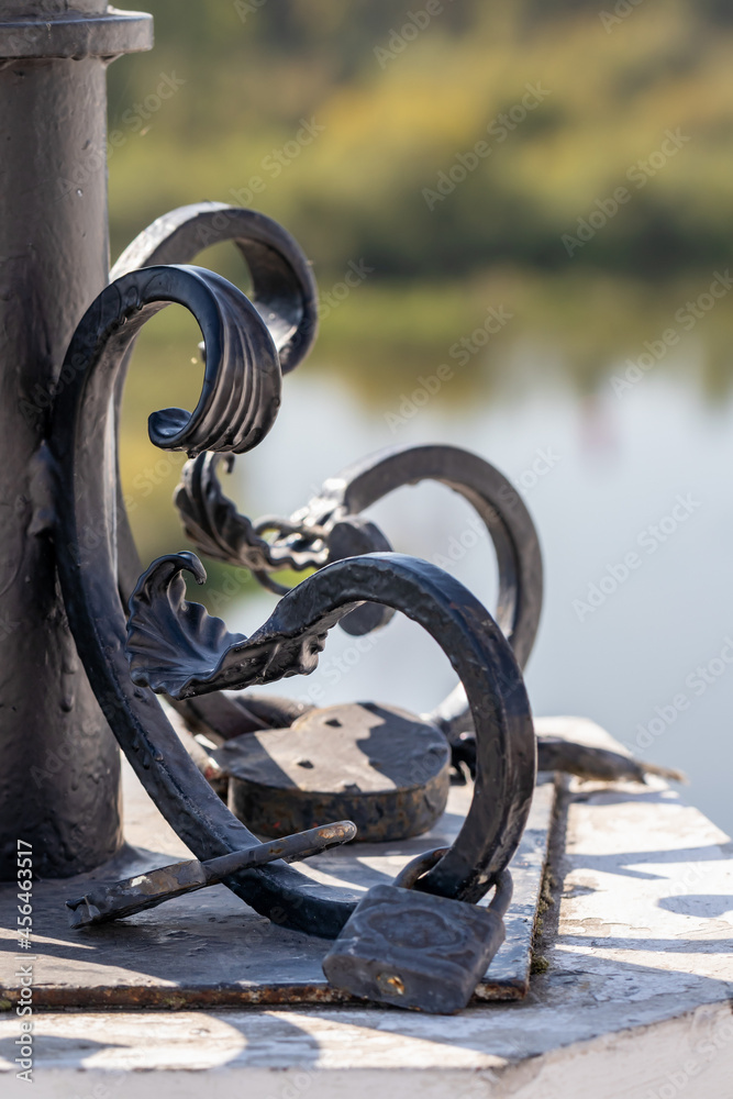 Forged elements in the architecture of the city. Curls and leaves with locks at the base of the decorative lamppost Forged elements in the architecture of the city. Curls and leaves with locks at the base of the decorative lamppost