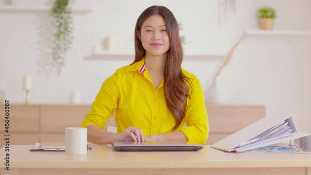 Asian Businesswoman finish work close computer laptop in workplace and looking at camera smile with confident emotional.Freelancer gesturing smile and happiness after Job done at home.Small Business Asian Businesswoman finish work close computer laptop in workplace and looking at camera smile with confident emotional.Freelancer gesturing smile and happiness after Job done at home.Small Business