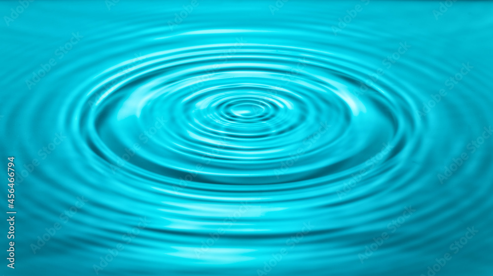 falling drops on the water surface, splash, ripples on the water, blue color falling drops on the water surface, splash, ripples on the water, blue color