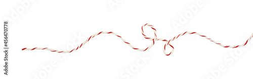 Obraz na plátně Curled white and red Christmas wrapping rope in a line arrangement isolated on w