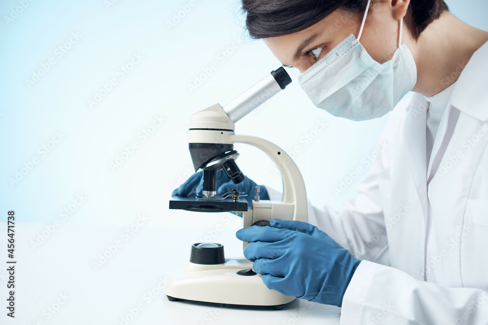 Woman in white coat microscope science work professionals Woman in white coat microscope science work professionals