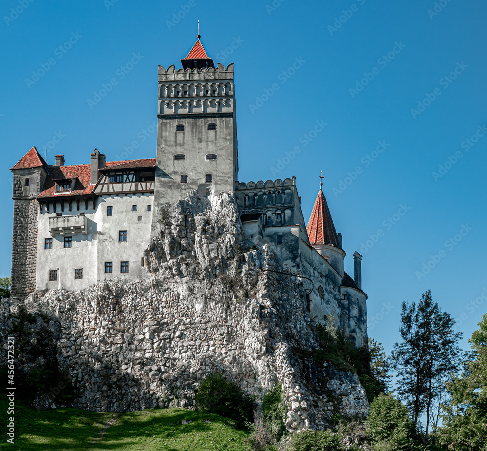 Bran castle exteriror built high on steep rock outcrop  hill