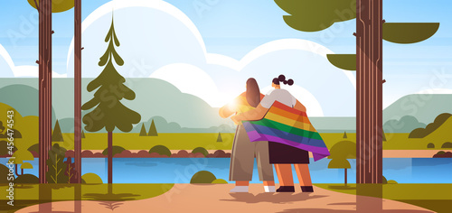 two girls holding lgbt rainbow flag gay lesbian love parade pride festival transgender love concept