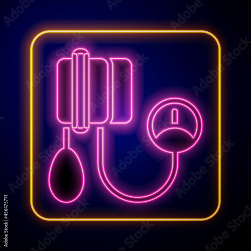 Glowing neon Blood pressure icon isolated on black background. Vector