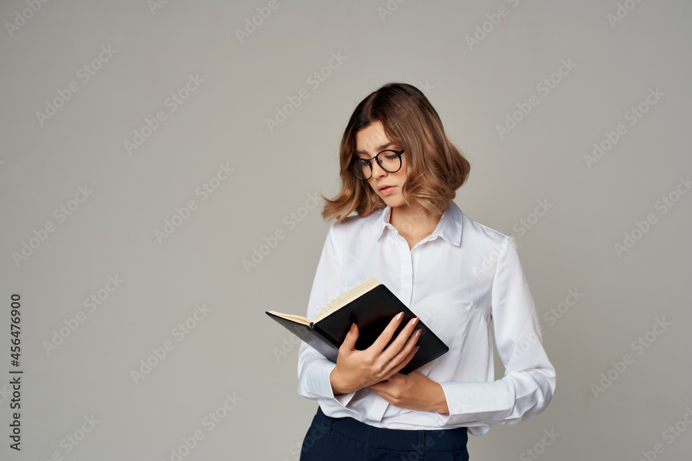 Business woman in glasses with documents in the hands of a professional office Business woman in glasses with documents in the hands of a professional office