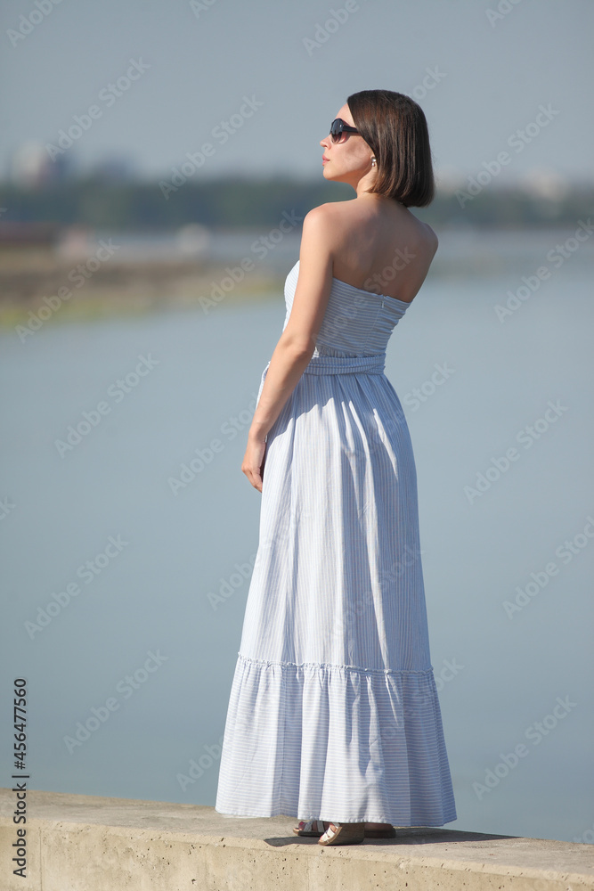 young woman in summer clothes by the sea young woman in summer clothes by the sea