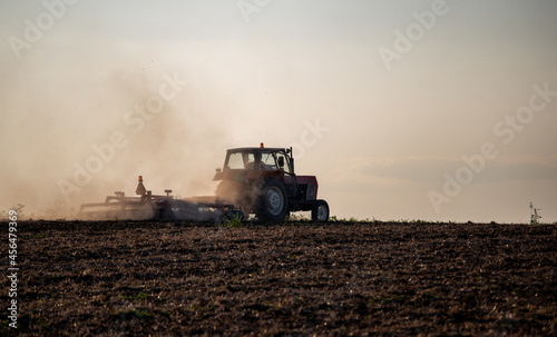 Tractor plowing field at sunset © Budimir Jevtic