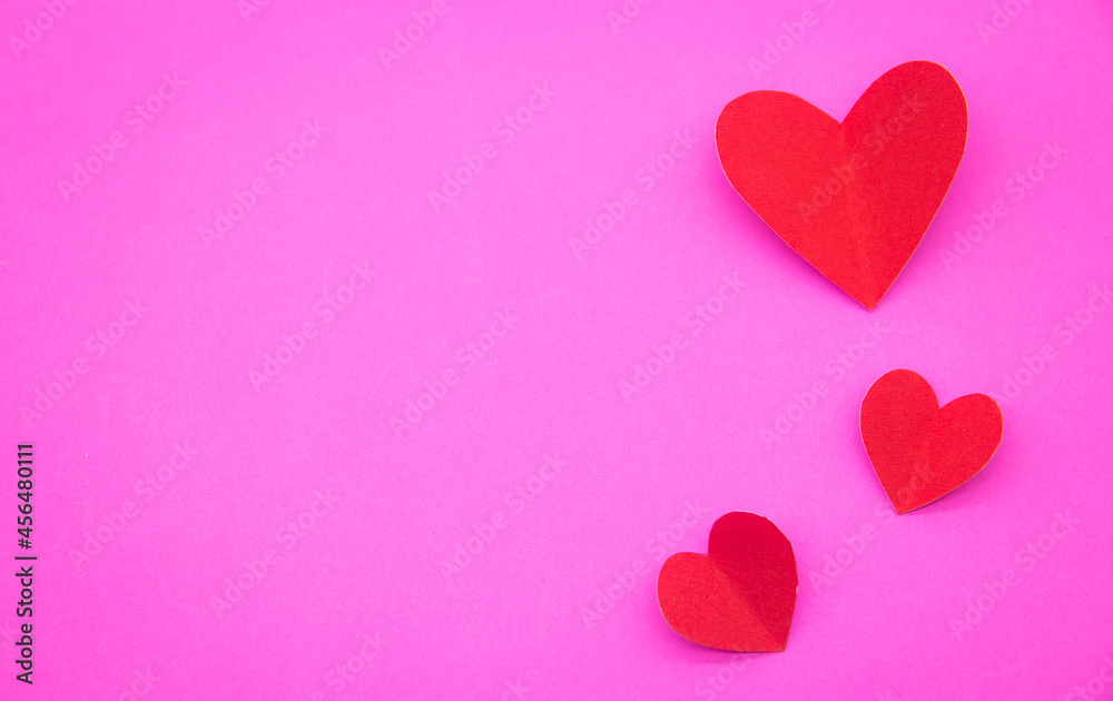 Valentine's day card Decorate with red heart gifts on a pink surface. Top view. Copy the area. Valentine's day card Decorate with red heart gifts on a pink surface. Top view. Copy the area.