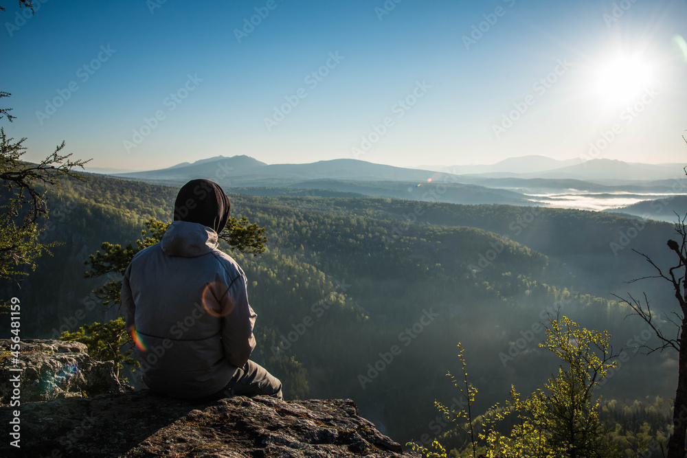 person sitting on a mountain
