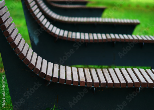 Empty deck-chairs in park background photo
