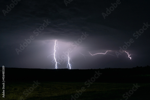 Multiple lightning strikes lighting up the sky on a summer evening during a thunderstorm