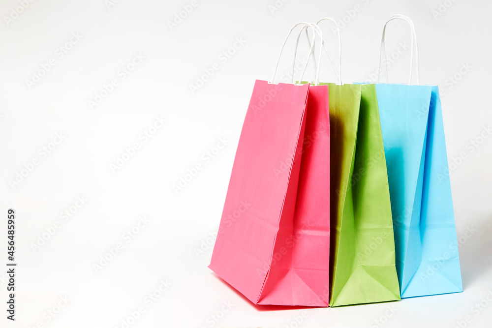 Colorful paper shopping bags on white background