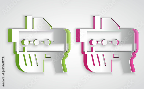 Paper cut Futuristic space gun blaster icon isolated on grey background. Laser Handgun. Alien Weapon. Paper art style. Vector