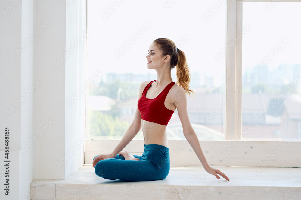 woman is engaged in meditation yoga asana near the window