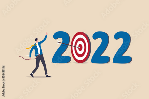 Year 2022 business target or personal development goal, new year resolutions, success plan or career achievement concept, ambitious businessman shoot arrow at target bullseye of year 2022 number.