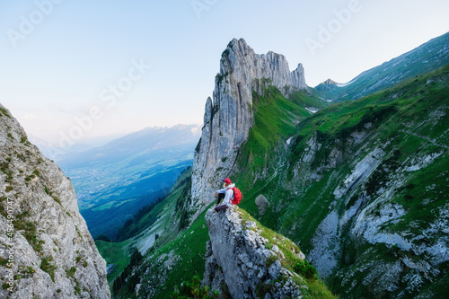 Tourist on the high rocks background. Sport and active life concept. Adventure and travel in the mountain region in the Switzerland mountains.