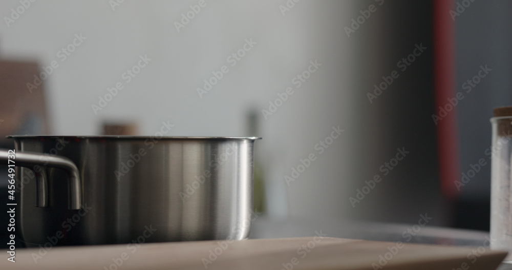 steam rising from saucepan with boiling water on stove steam rising from saucepan with boiling water on stove