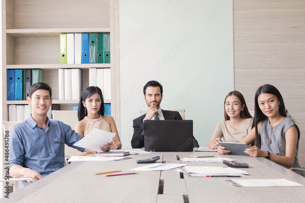 Portrait of manager and his team at meeting room in office. Portrait of manager and his team at meeting room in office.