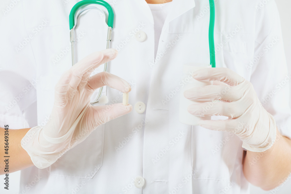 Close up image of transparent capsule holding by a doctore Close up image of transparent capsule holding by a doctore