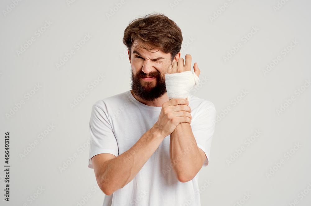 bearded man bandaged hand injury to fingers hospitalization isolated background bearded man bandaged hand injury to fingers hospitalization isolated background