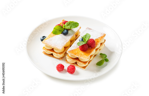 Classic french dessert millefeuille with vanilla cream and fresh berries. isolated on white background 