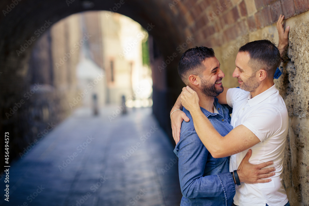 Gay couple hugging in a romantic moment outdoors Gay couple hugging in a romantic moment outdoors