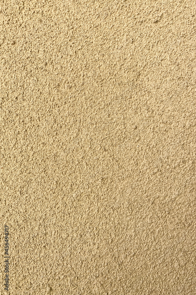 Brown background of fine plaster outdoors in sun. Brown background of fine plaster outdoors in sun.