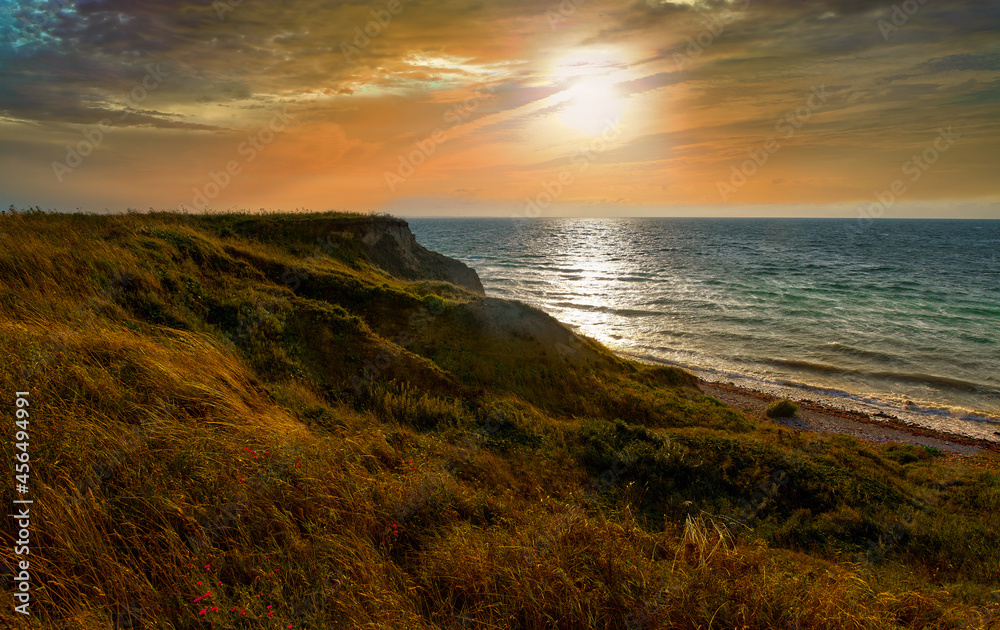 Photo of the sea evening landscape. Evening sea, sunset, dunes and hills, beautiful coast and waves.