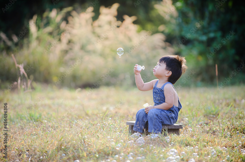 Portrait of funny lovely little boy blowing soap bubbles Portrait of funny lovely little boy blowing soap bubbles