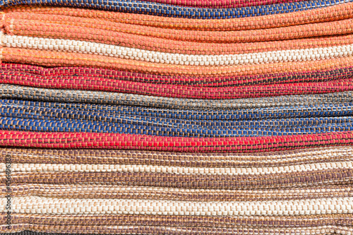 a stack of colorful carpets