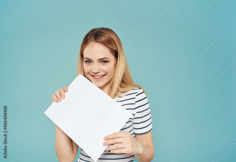 blonde girl in striped t-shirt fun glamor posing blue background