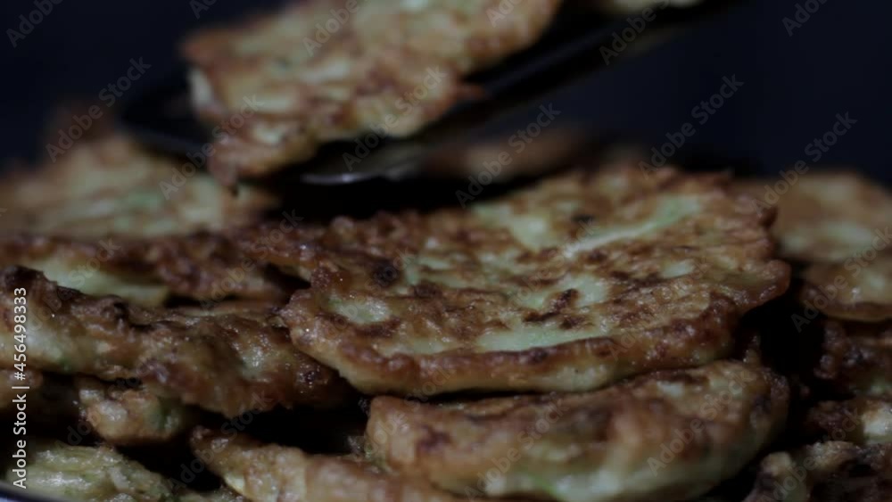 Freshly fried squash pancakes are laid out on a plate Freshly fried squash pancakes are laid out on a plate