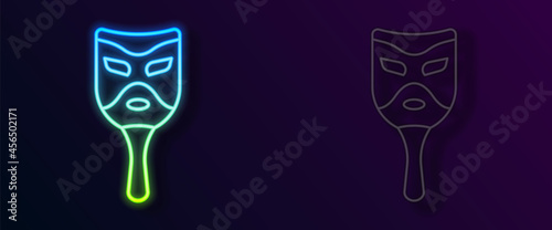 Glowing neon line Carnival mask icon isolated on black background. Masquerade party mask. Vector