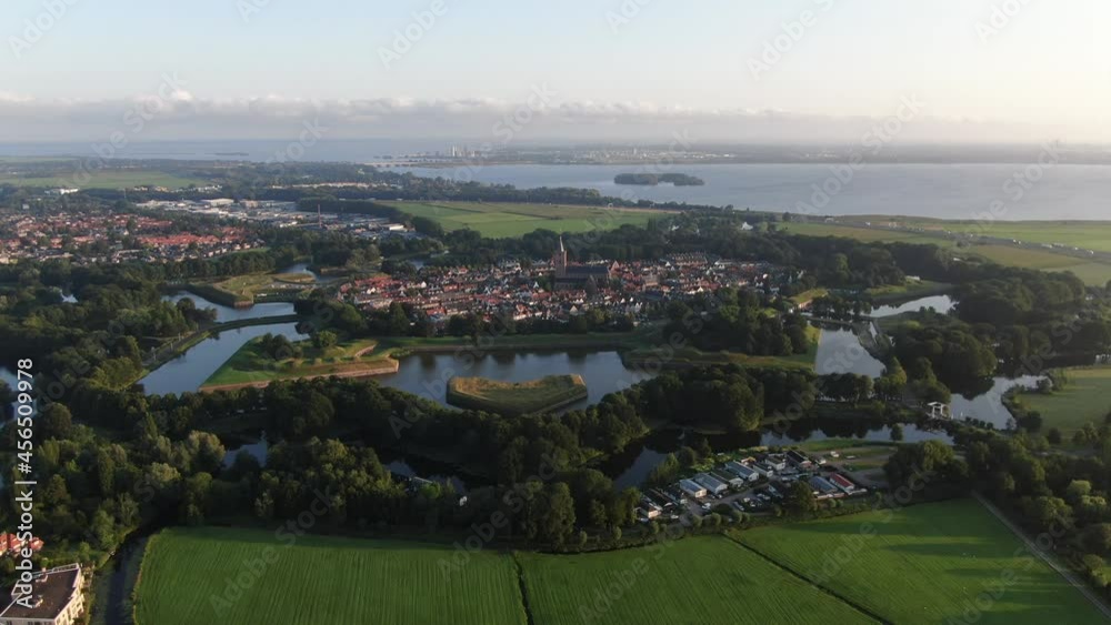 4k aerial video of the star shaped Naarden fortification village in the Netherlands at sunrise 